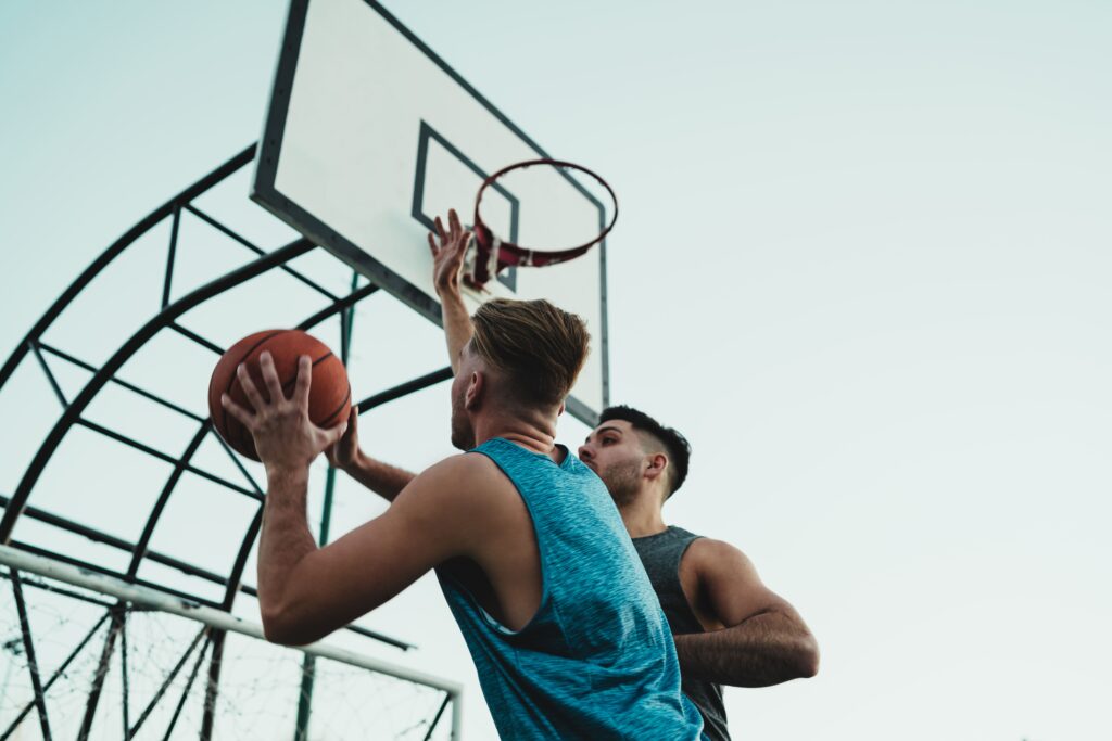 young basketball players playing one on one